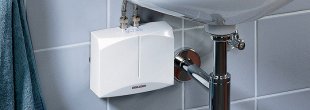 Point-of-use tankless water heater under bathroom sink